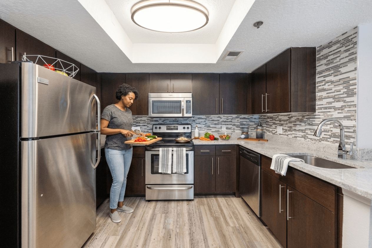 A woman is preparing food in a modern kitchen.